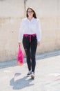 A young modern woman with purchases. Girl carries fruits and vegetables in an eco-friendly string, reusable net bag. Organic