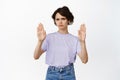 Young modern woman show block, stop no gesture, decline, rejecting something, raise palms and frowning, refusing smth Royalty Free Stock Photo