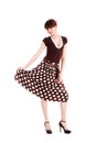 Young modest beautiful girl in spotted skirt Royalty Free Stock Photo