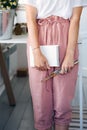 Young modest woman holding paper notebook and brushes in her hands Royalty Free Stock Photo