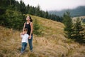 Young mom with baby boy travelling. Mother on hiking adventure with child, family trip in mountains. National Park. Hike with Royalty Free Stock Photo