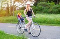 Young mom with baby riding bicycle