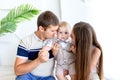 Young mom and dad look at a child, parents with a child in a photo Studio, family day, happy family Royalty Free Stock Photo