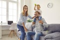 Young mom, dad and their son have fun together at home on the weekend playing tennis balls. Royalty Free Stock Photo