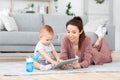 Young Mom And Her Baby Son Playing Delevelopment Games On Digital Tablet Royalty Free Stock Photo