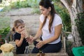 Young mom with her little daughter preparing for recycling different kind of rubbish and putting them into special Royalty Free Stock Photo