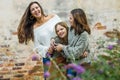 A young mom in her 30& x27;s with her two daughters outside hugging and laughing together Royalty Free Stock Photo