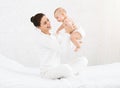 Young mom holding her happy baby in air Royalty Free Stock Photo