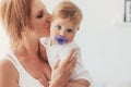 Young mom kissing her 8 month baby Royalty Free Stock Photo