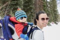 Young Mom Snowshoeing with her Baby in a Backpack