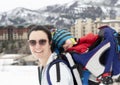 Young Mom Snowshoeing with her Baby in a Backpack