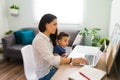 Young mom working at home with her baby Royalty Free Stock Photo