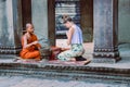 Young monk blessed a tourist in a temple
