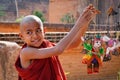 A young monk playing with puppets in Bagan, Myanmar Royalty Free Stock Photo