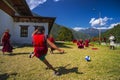 A young monk shot a goal , monks play football . Trashiyangtse Dzong , eastern Bhutan