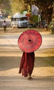A young monk with umbrella in Bagan, Myanmar