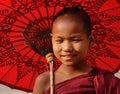 A young monk with the umbrella in Mandalay, Myanmar Royalty Free Stock Photo