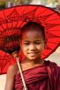 A young monk with the umbrella in Mandalay, Myanmar