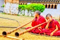 Young monks are blowing instruments at the Chimi Lhakhang, Punakha, Bhutan