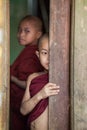 Young monks looking out of a window