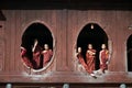 Young monks at window of wooden Church in temple.