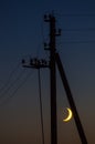 The young Moon with a power line. Royalty Free Stock Photo