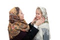 Young mother adjusts her shawl on the head daughter Royalty Free Stock Photo