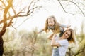 Young mother with adorable daughter in park with blossom tree