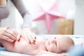 Young mother applying talc to a baby