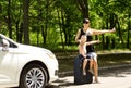 Young mother asking for a lift by the roadside