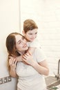 Mother and child son cleaning dishes together Royalty Free Stock Photo