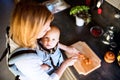 Young mother with a baby boy doing housework. Royalty Free Stock Photo