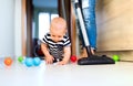 Young mother with a baby boy doing housework. Royalty Free Stock Photo