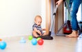 Young mother with a baby boy doing housework. Royalty Free Stock Photo