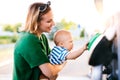 Young mother with baby boy at the petrol station. Royalty Free Stock Photo