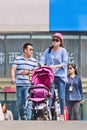 Young mother with baby car on pedestrian bridge, Beijing, China