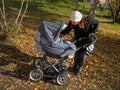 Young mother with baby carriage