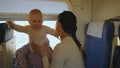 Young mother with baby in her arms traveling by train