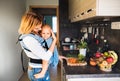 Young mother with a baby boy doing housework. Royalty Free Stock Photo