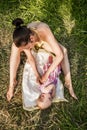 The Young mother baby swaddles outdoors on a summer day Royalty Free Stock Photo