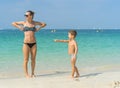 Young mother in black sunglasses and smiling baby boy son playing in the sea in the day time. Positive human emotions, feelings, j Royalty Free Stock Photo