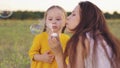 young mother blowing soap bubbles with little girl daughter. happy family. fun family bubble blowing game. child kid Royalty Free Stock Photo