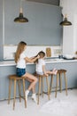 Young mother braids her daughter`s hair