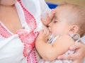 Young mother breastfeeds her baby.