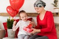 Young mother, cancer patient, and her cute daughter, celebrating return home from hospital. Welcome home or birthday party. Royalty Free Stock Photo