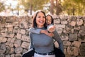 Young mother carries her daughter on his back. Little girl excited and smiling pointing wit the finger Royalty Free Stock Photo