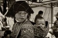 A young mother carry her infant on her back at Sapa, Vietnam