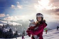 Young mother, carrying her baby boy in sling, climbing on peak w Royalty Free Stock Photo