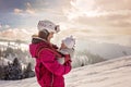 Young mother, carrying her baby boy in sling, climbing on peak w Royalty Free Stock Photo