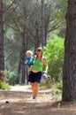 Young mother carrying her son and walking through woods Royalty Free Stock Photo